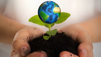 Hands with earth (Elements of this image furnished by NASA)